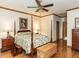 Comfortable bedroom with a four-poster bed, wood floors, and ample natural light at 422 Old Scarborough Ln, Garner, NC 27529