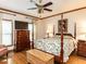 Charming main bedroom features a four-poster bed and hardwood floors at 422 Old Scarborough Ln, Garner, NC 27529