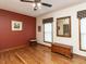 Bedroom with hardwood flooring, ceiling fan, and natural lighting from the windows at 422 Old Scarborough Ln, Garner, NC 27529