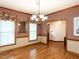 Formal dining area featuring hardwood floors, classic wainscoting, and natural lighting at 422 Old Scarborough Ln, Garner, NC 27529
