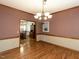 Elegant dining room with hardwood floors, wainscoting, and decorative chandelier at 422 Old Scarborough Ln, Garner, NC 27529