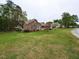 Expansive lawn showcasing a traditional brick home with mature trees and landscaping at 422 Old Scarborough Ln, Garner, NC 27529