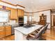Well-appointed kitchen featuring an island cooktop, stainless appliances, and sunlit breakfast area at 422 Old Scarborough Ln, Garner, NC 27529