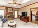Inviting living room features a brick fireplace, ceiling fan, and door to the outside at 422 Old Scarborough Ln, Garner, NC 27529