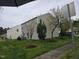 Backyard with green grass, landscaping, and exterior of home in background at 4610 Miller Dr, Durham, NC 27704
