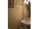 Half bathroom with a single sink vanity and wall mounted mirror at 4610 Miller Dr, Durham, NC 27704