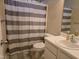 Updated bathroom featuring a white vanity, mirror, and striped shower curtain at 4610 Miller Dr, Durham, NC 27704