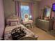 Bedroom featuring a vanity with lighted mirror, gray dresser, and a window at 4610 Miller Dr, Durham, NC 27704