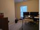 Bedroom featuring desk, two monitors, with neutral carpet and a window for natural light at 4610 Miller Dr, Durham, NC 27704