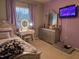Bedroom featuring a vanity with lighted mirror, gray dresser, and a window at 4610 Miller Dr, Durham, NC 27704