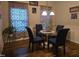 Cozy dining room with a glass table, chair set, and natural light at 4610 Miller Dr, Durham, NC 27704