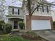 View of the home's entry way featuring a well manicured green bushes next to the front door at 4610 Miller Dr, Durham, NC 27704