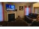 Cozy living room with a fireplace, plush leather seating, and a flat-screen television at 4610 Miller Dr, Durham, NC 27704