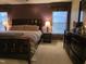 The main bedroom offers a dark accent wall, neutral carpet, and natural light at 4610 Miller Dr, Durham, NC 27704