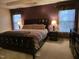This spacious main bedroom features a decorative tray ceiling, windows, and neutral carpet at 4610 Miller Dr, Durham, NC 27704