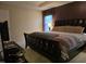 Spacious main bedroom boasts a decorative tray ceiling and large window at 4610 Miller Dr, Durham, NC 27704