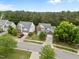An aerial view showcasing the charming two-story home with an attached garage and well-maintained landscaping at 4709 Knights Arm Dr, Durham, NC 27707