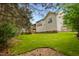 Backyard with a large lawn, home's exterior, a staircase leading to an upper deck and trees at 4709 Knights Arm Dr, Durham, NC 27707