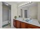 Bathroom with cherry wood cabinets, white counter, and shower and tub combo at 4709 Knights Arm Dr, Durham, NC 27707