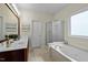 Bathroom featuring double sinks, a separate shower, and a soaking tub at 4709 Knights Arm Dr, Durham, NC 27707