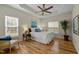 Bedroom with tray ceiling, hardwood floors, and lots of natural light at 4709 Knights Arm Dr, Durham, NC 27707
