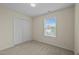 Bedroom with neutral walls, plush carpet, and a double door closet at 4709 Knights Arm Dr, Durham, NC 27707