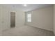 Bedroom with neutral walls, plush carpet, a window, and walk in closet at 4709 Knights Arm Dr, Durham, NC 27707