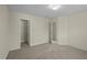 Bedroom with neutral walls and plush carpet with view to closet and hallway at 4709 Knights Arm Dr, Durham, NC 27707