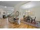 Open concept dining room with hardwood floors, neutral paint, and modern chandelier at 4709 Knights Arm Dr, Durham, NC 27707