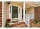 This covered front porch boasts a decorative wreath and space for potted plants at 4709 Knights Arm Dr, Durham, NC 27707
