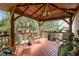 Backyard gazebo features wood flooring and roof, garden views, and comfortable seating at 4709 Knights Arm Dr, Durham, NC 27707