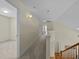 Upstairs hallway with carpeted floor, neutral walls, and view to the stairs at 4709 Knights Arm Dr, Durham, NC 27707