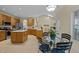 Spacious kitchen with oak cabinets, an island, tile floors, and an adjacent breakfast nook at 4709 Knights Arm Dr, Durham, NC 27707
