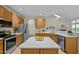 Kitchen with quartz counters, stainless steel appliances, and view to fireplace at 4709 Knights Arm Dr, Durham, NC 27707