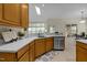 Well-lit kitchen with oak cabinets, light countertops, stainless steel appliances, and a skylight at 4709 Knights Arm Dr, Durham, NC 27707