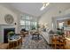 Bright living room with vaulted ceilings, gas fireplace, and hardwood floors at 4709 Knights Arm Dr, Durham, NC 27707