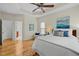 Bright main bedroom features a tray ceiling, a ceiling fan, and hardwood floors at 4709 Knights Arm Dr, Durham, NC 27707