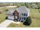 Spacious two-story home with attached garage on a large lot surrounded by a white fence at 4905 Homestead Dr, Mebane, NC 27302