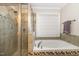 Bright bathroom featuring tiled shower, soaking tub, and neutral decor at 4905 Homestead Dr, Mebane, NC 27302