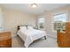 Cozy bedroom featuring two large windows, wood furniture, and neutral tones at 4905 Homestead Dr, Mebane, NC 27302