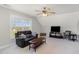 Bonus room with tv, seating, and natural light from the window at 4905 Homestead Dr, Mebane, NC 27302