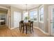 Bright dining area featuring hardwood floors, pendant lighting, and multiple windows offering pleasant outdoor views at 4905 Homestead Dr, Mebane, NC 27302