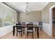 Bright dining room featuring a wooden table, light hardwood flooring, and large window, perfect for Gathering gatherings at 4905 Homestead Dr, Mebane, NC 27302