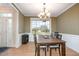 Elegant dining room with a chandelier, hardwood floors, and a large window with a view at 4905 Homestead Dr, Mebane, NC 27302