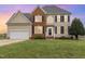 Charming two-story home features a brick facade, black shutters, and a well-manicured lawn at 4905 Homestead Dr, Mebane, NC 27302