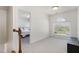 Bright hallway with a view into a bedroom and a large window overlooking the neighborhood at 4905 Homestead Dr, Mebane, NC 27302