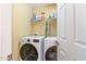 Tidy laundry room featuring a modern washer and dryer set and storage shelves at 4905 Homestead Dr, Mebane, NC 27302
