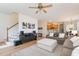 Spacious living room with a large sofa, ceiling fan, hardwood floors, and open layout at 4905 Homestead Dr, Mebane, NC 27302