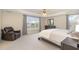 Spacious main bedroom featuring a ceiling fan, neutral carpet, and large windows offering plenty of natural light at 4905 Homestead Dr, Mebane, NC 27302
