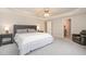 Comfortable main bedroom with neutral walls, carpet, and a tray ceiling, offering a serene retreat with ample space at 4905 Homestead Dr, Mebane, NC 27302